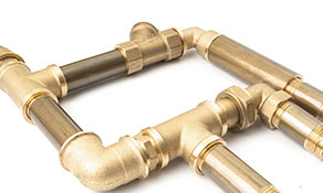 A close-up of a set of copper water pipes.