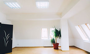 A spacious empty room in a landlord's rental property.