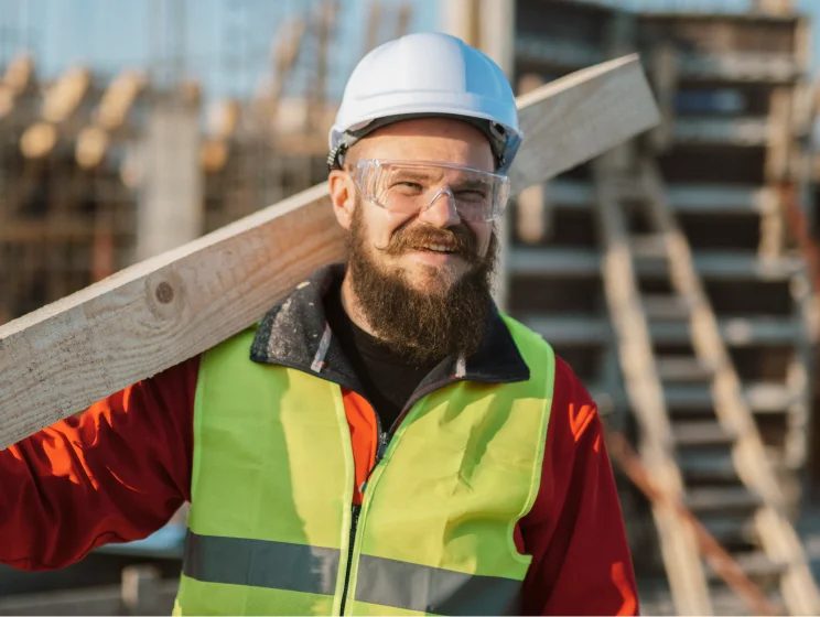 smiling tradesperson wearing a hard hat