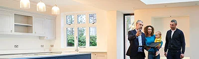 An estate agent is showing a young family around a new house.